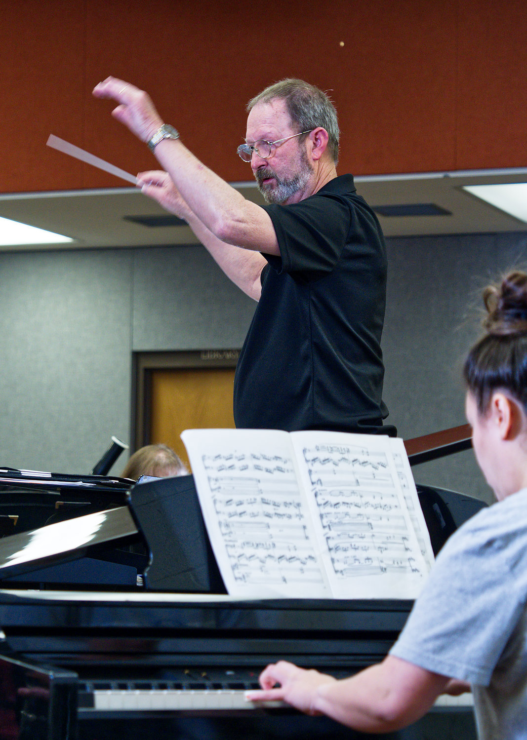 Jennifer Lynn Turner practices her solo from “Warsaw Concerto” as Mike Holbrook directs.